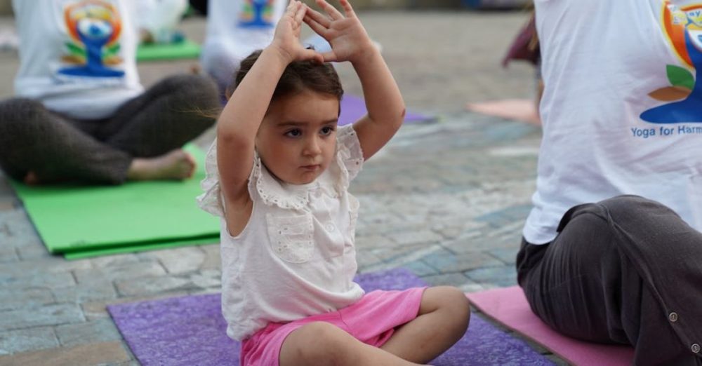 Matting - A little girl is doing yoga with her mother