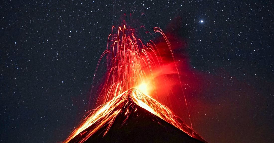 Destructive Behavior - Volcano Erupting at Night Under Starry Sky